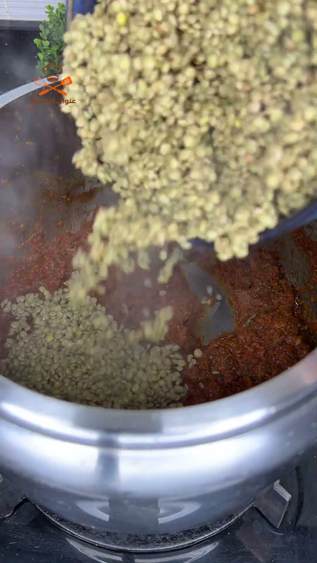 Pouring soaked green lentils into the sauce