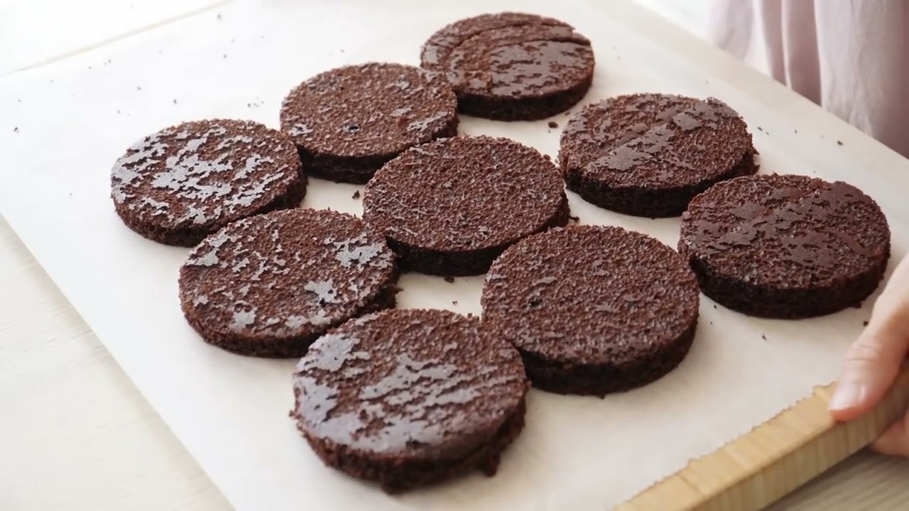 Nine chocolate cake rounds cut from one sheet cake with an 8 cm cutter