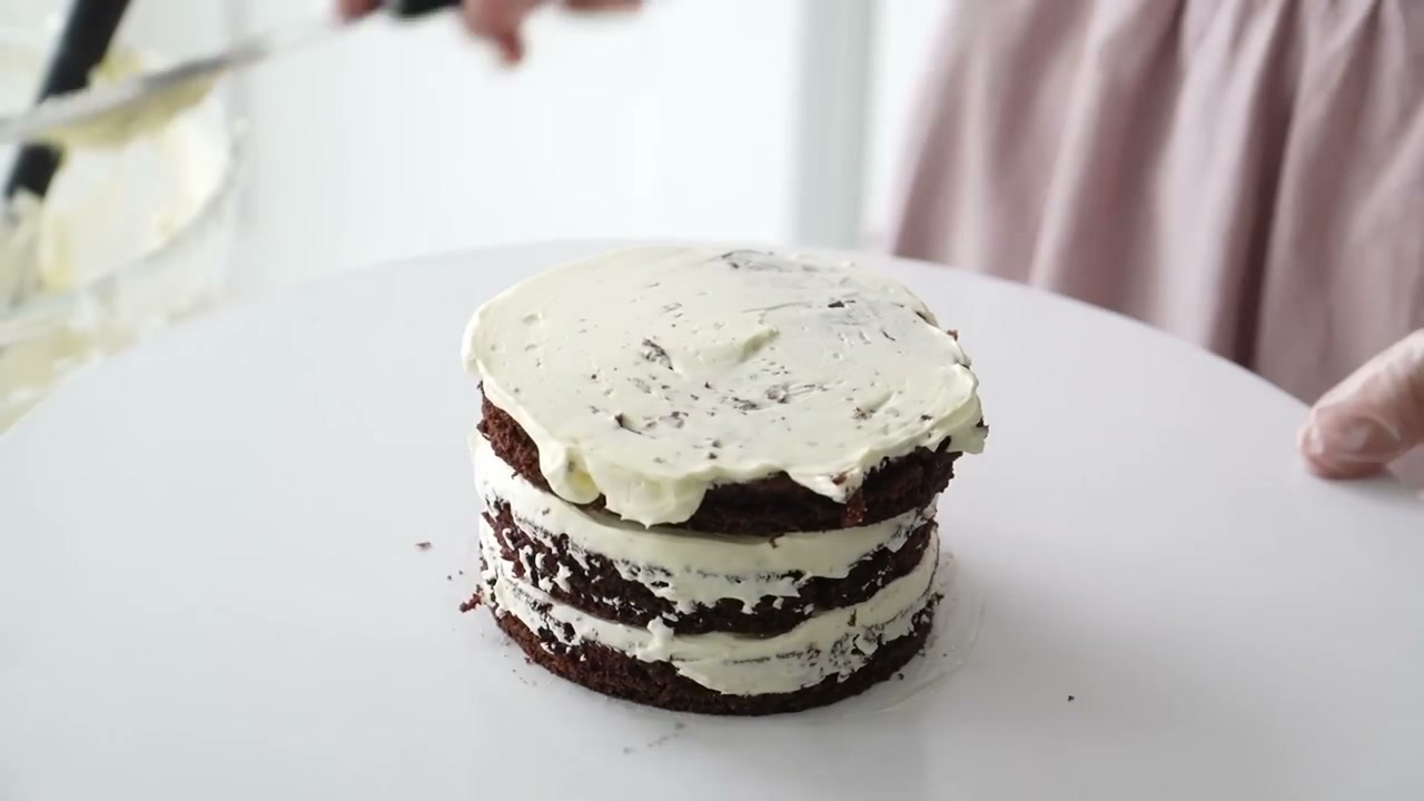 A three-layer mini cake with a thin crumb coat of buttercream