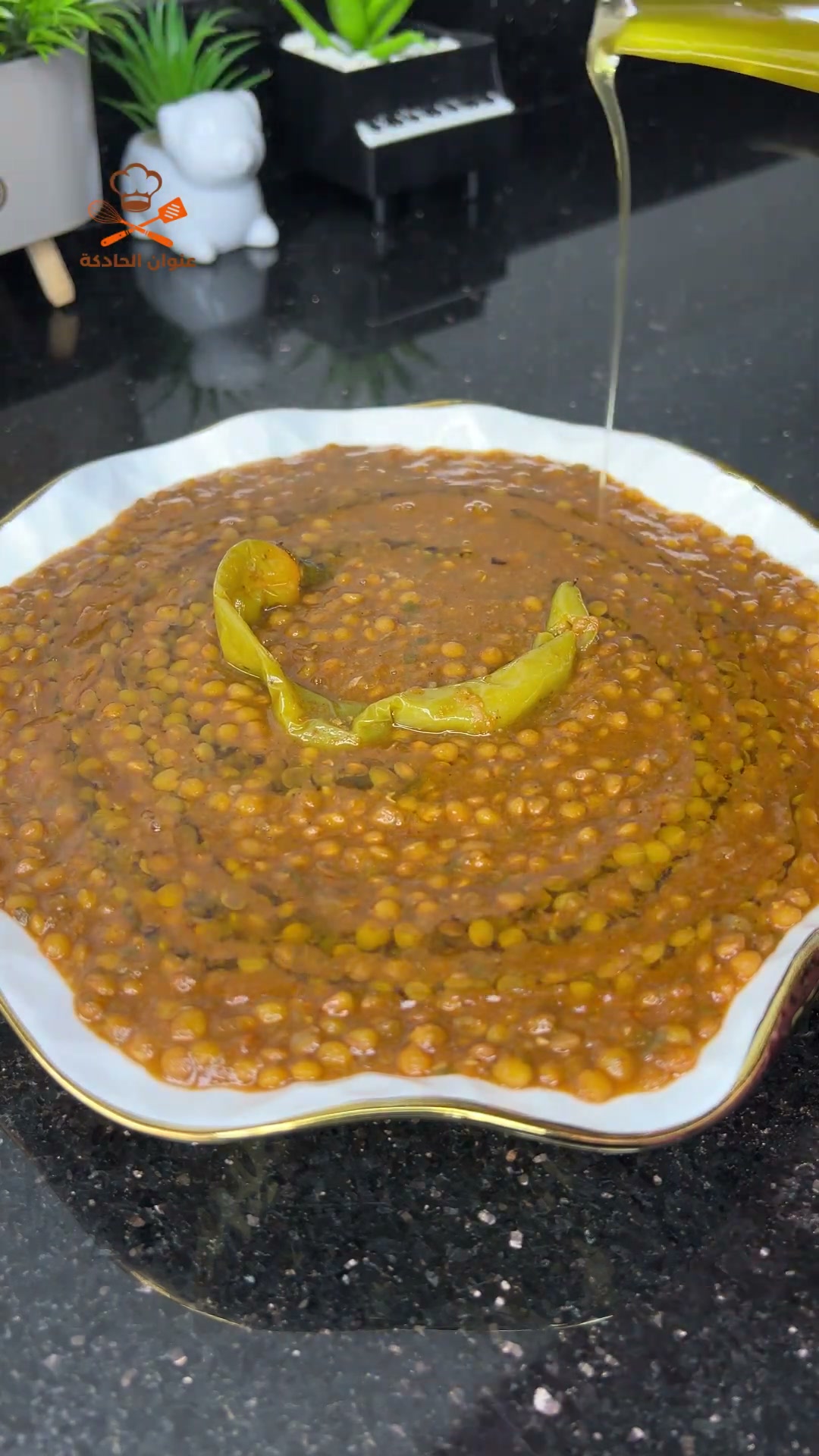 Drizzling olive oil over a bowl of Moroccan lentils