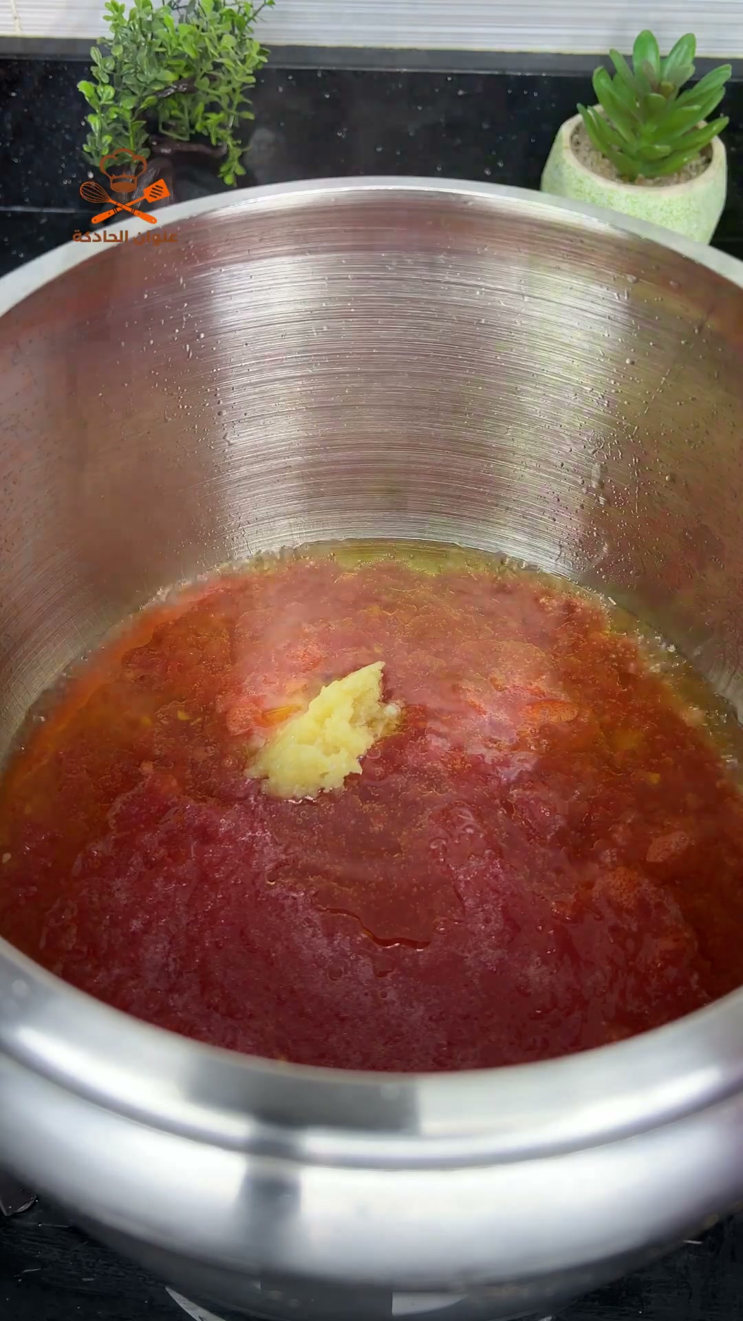 Grated tomatoes and crushed garlic in a pressure cooker with oil