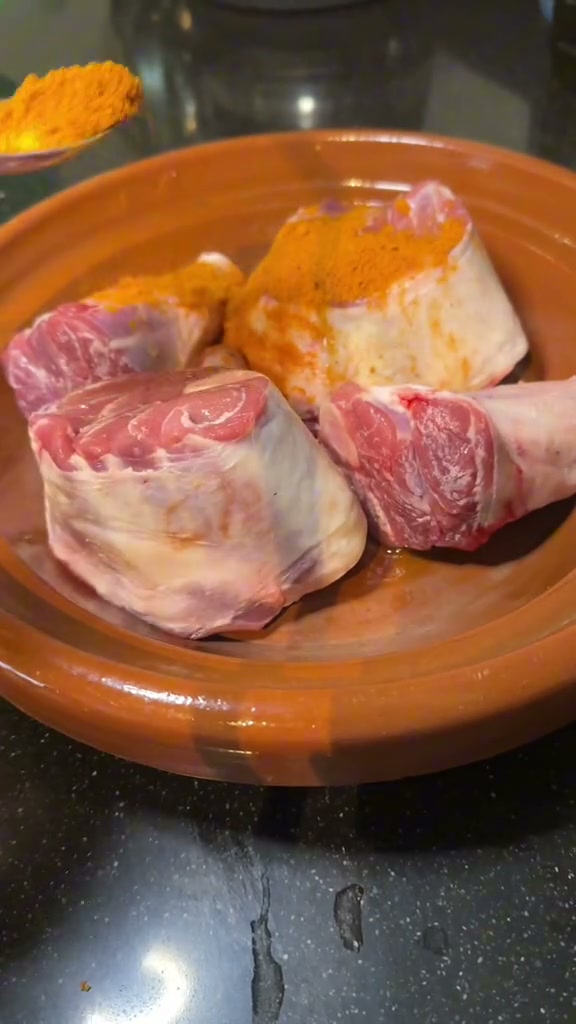 Lamb shanks in a clay tagine dusted with ginger, turmeric, paprika and ras el hanout