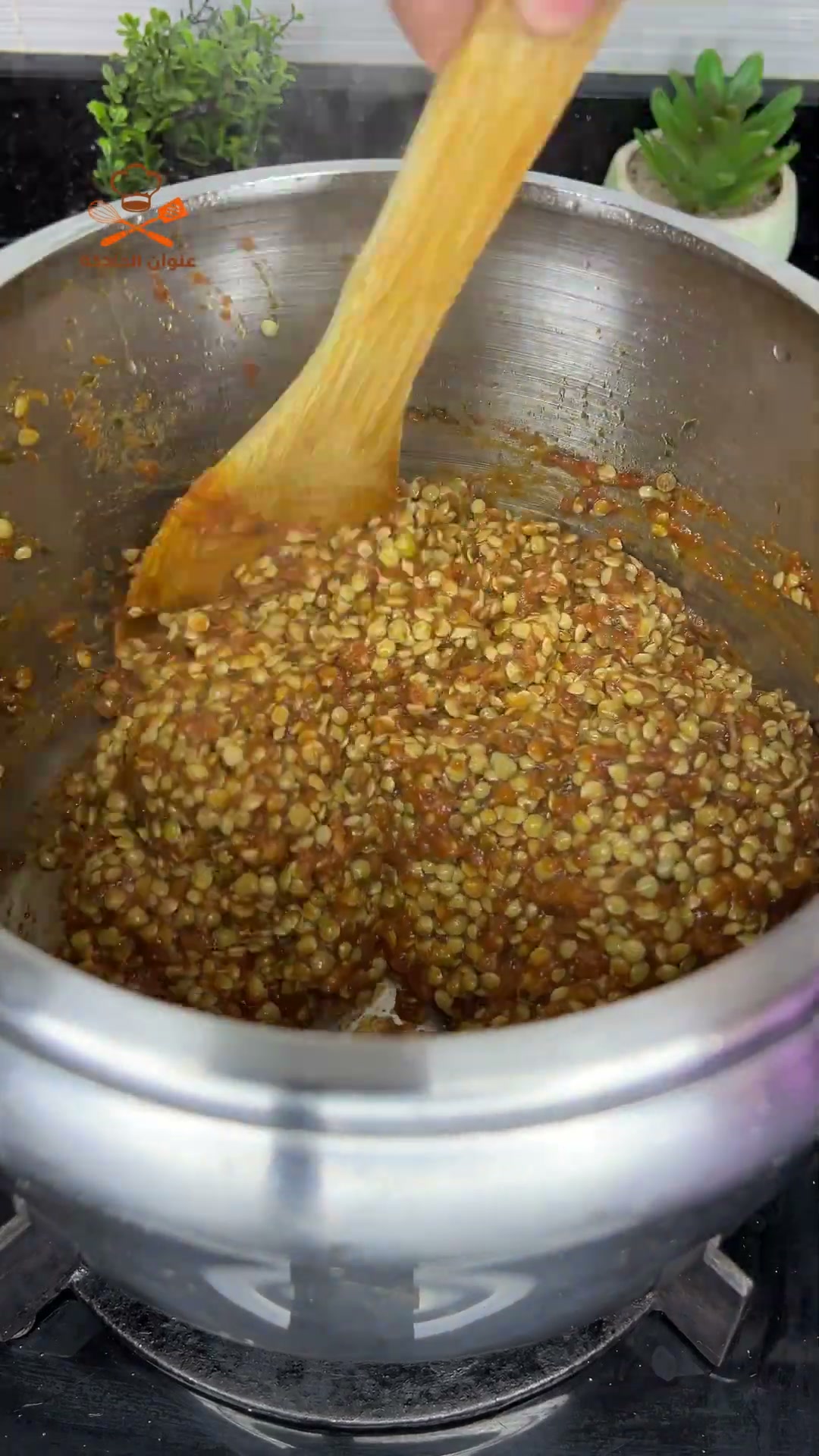 Stirring the lentils to coat them in the spiced sauce