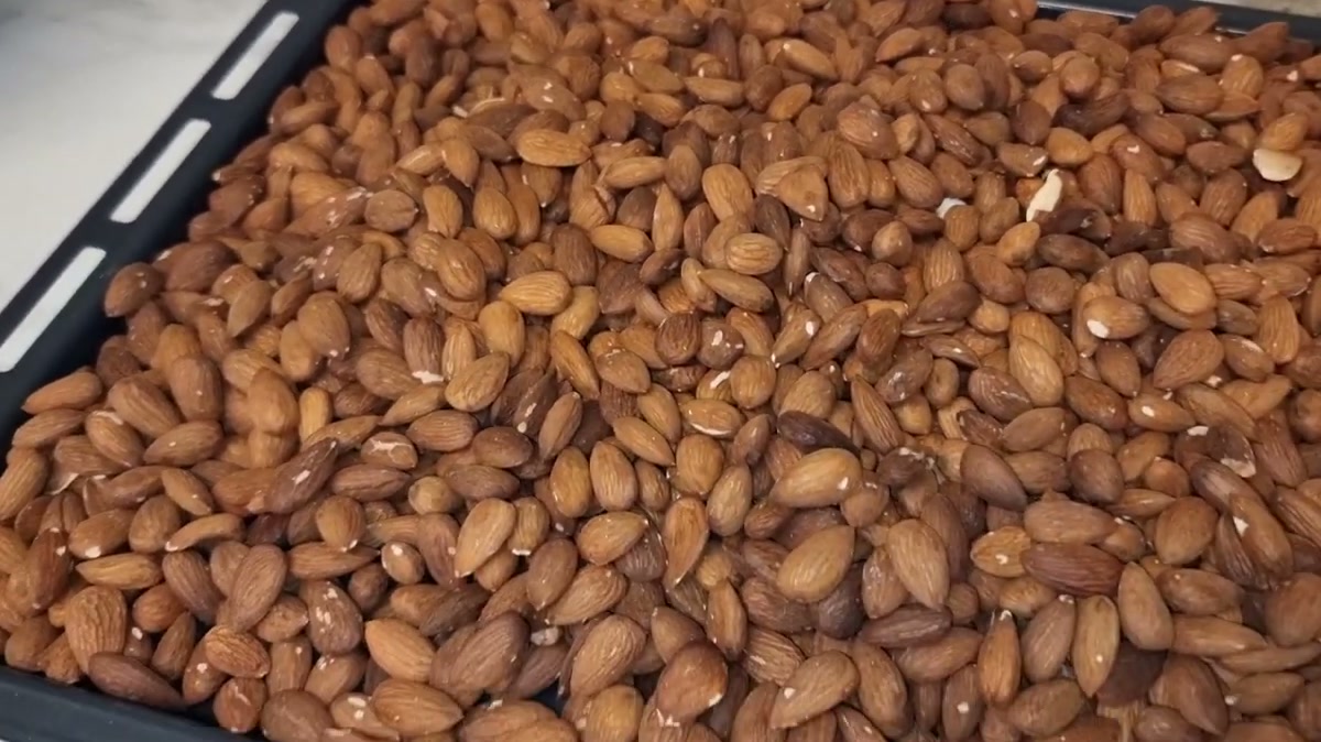 Almonds with their skin roasted under the oven grill on a baking tray