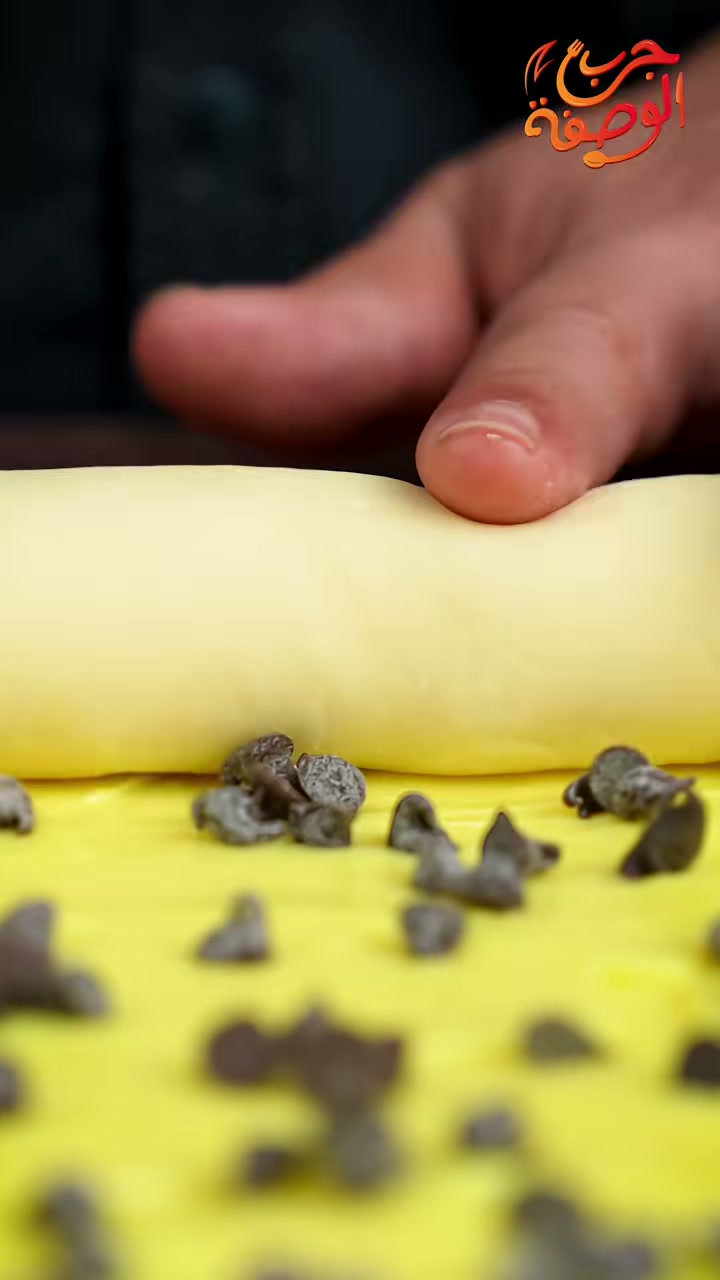 Rolling up the dough over pastry cream and chocolate chips