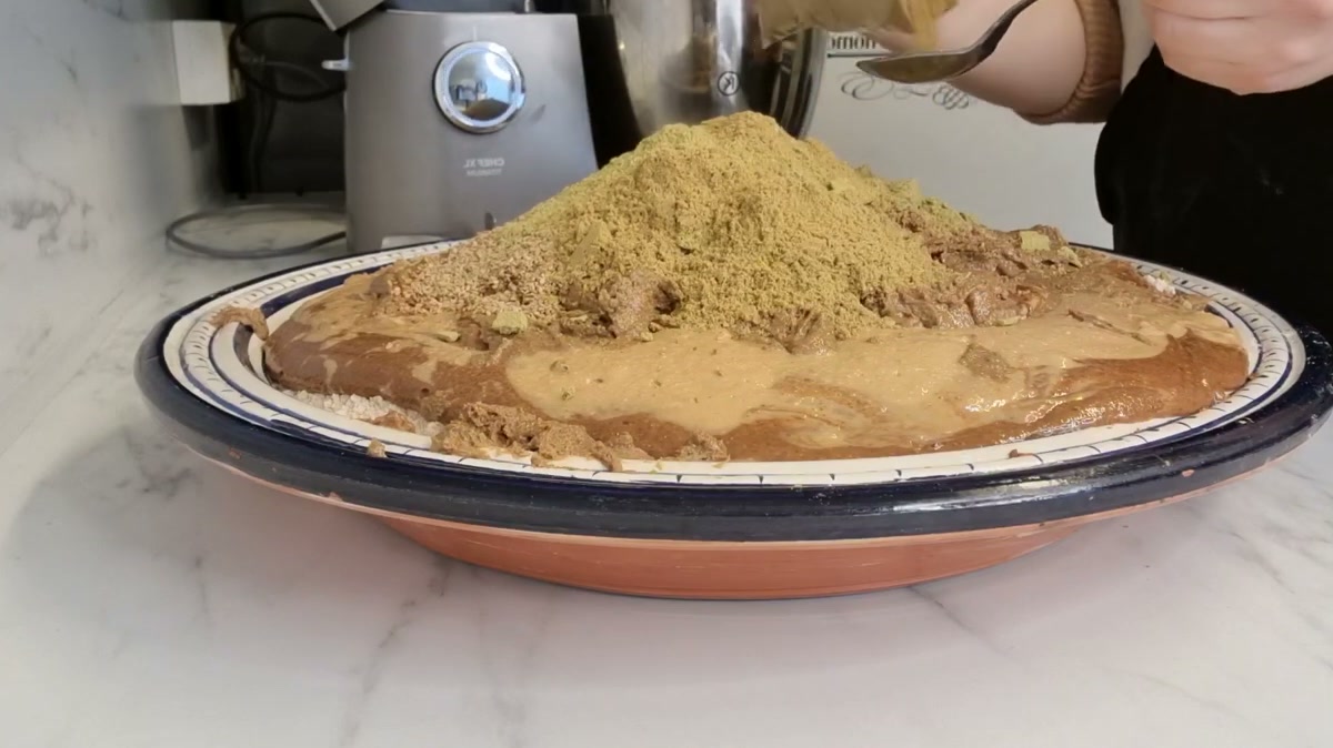 Ground sesame, fennel, gum arabic and anise piled on the flour and nut pastes before mixing