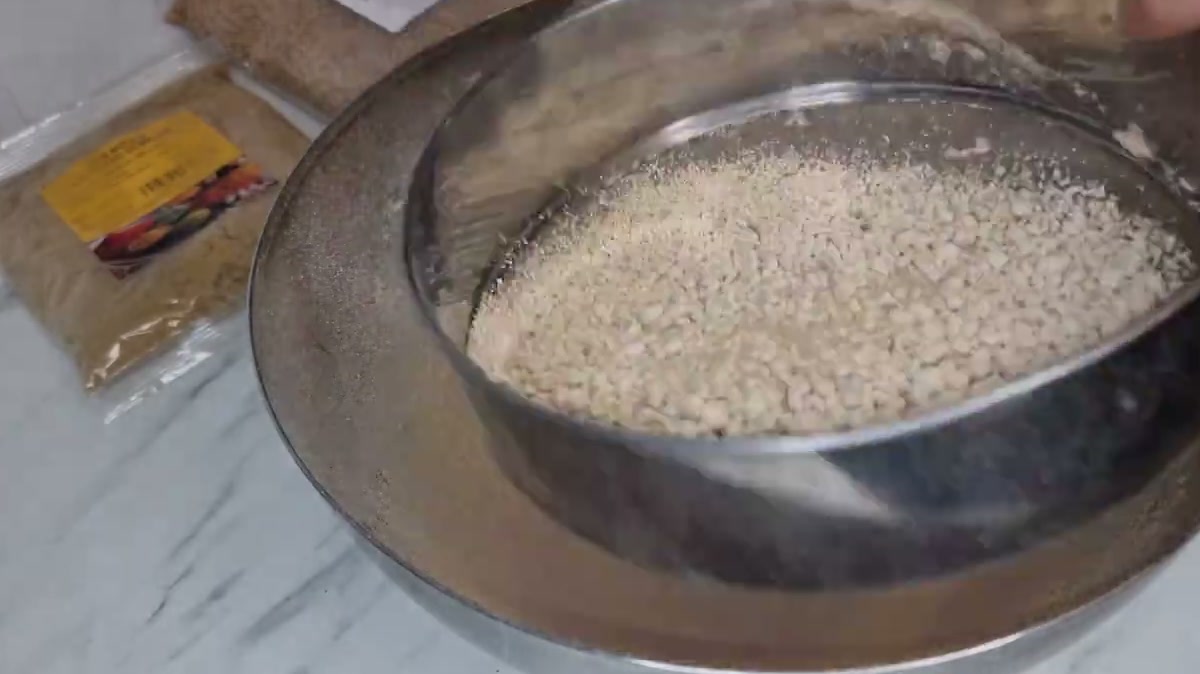 Sifting the golden toasted flour through a fine sieve