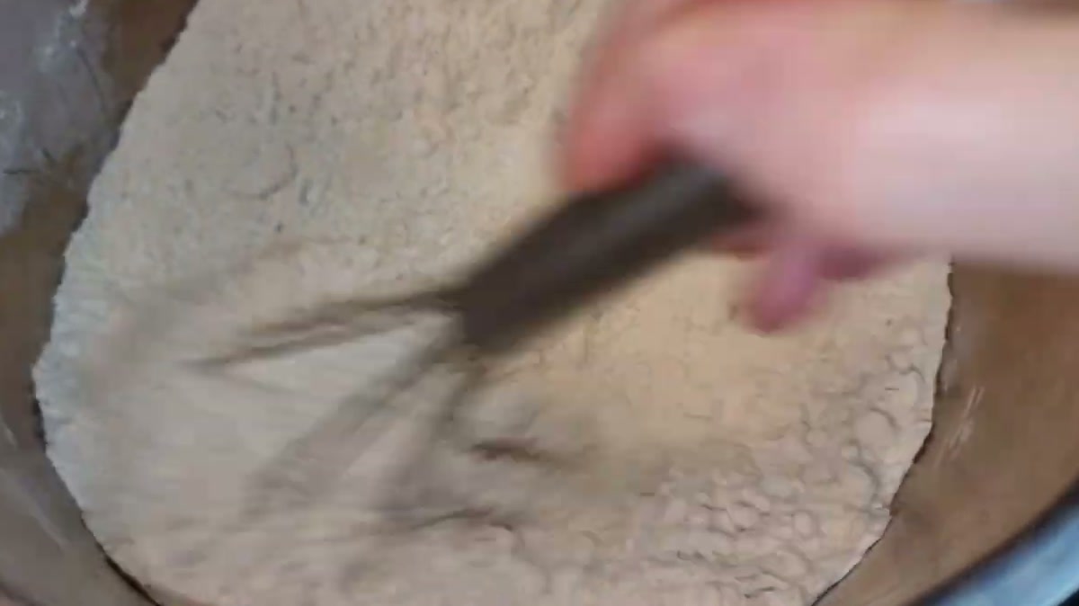 Toasting flour in a heavy pot over low heat, stirring with a whisk